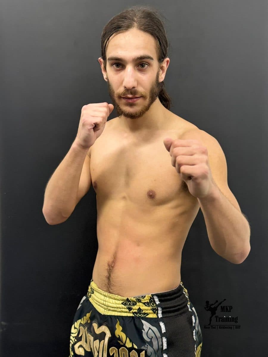 High kick checked by a sparring partner in the ring